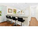 Kitchen with breakfast bar, granite countertops and white cabinets at 2310 Lark Ln # 22, Sarasota, FL 34231