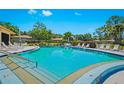 Inviting community pool with plenty of lounge chairs at 2310 Lark Ln # 22, Sarasota, FL 34231