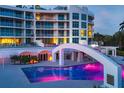 Resort-style pool and bridge at night, with building in background at 2251 Gulf Of Mexico Dr # 301, Longboat Key, FL 34228