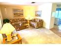 Bright living room with two sofas, a coffee table, and ample natural light at 2434 Fourwind St, Port Charlotte, FL 33948