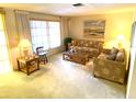 Bright living room with two sofas, a coffee table, and ample natural light at 2434 Fourwind St, Port Charlotte, FL 33948