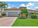 Beautiful home exterior with a two-car garage and landscaping at 13116 Treviso Dr, Bradenton, FL 34211