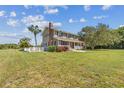 Two-story house with a side yard, white fence, and palm trees at 1914 24Th W Ave, Palmetto, FL 34221