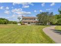 Two-story house with a long driveway and expansive lawn at 1914 24Th W Ave, Palmetto, FL 34221