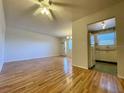 Bright living room with wood-look floors and access to kitchen at 4480 Ironwood Cir # 305A, Bradenton, FL 34209