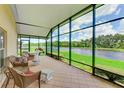 Relaxing screened porch overlooking a tranquil lake at 9861 50Th Street E Cir, Parrish, FL 34219