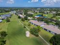 Beautiful aerial view of condos situated on a golf course with lakes, lush landscaping and mature trees at 6904 Drewrys Blf # 803, Bradenton, FL 34203