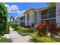 Charming condo exterior features lovely landscaping, sidewalks, screened balconies, and a bright, white facade at 6904 Drewrys Blf # 803, Bradenton, FL 34203