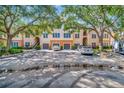 Exterior view of a building with parking and lush landscaping at 4126 Central Sarasota Pkwy # 2026, Sarasota, FL 34238