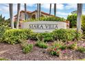 Community entrance with landscaped grounds and signage at 7365 Regina Royale Blvd # 10, Sarasota, FL 34238