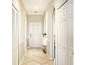 Bright hallway with tile flooring and neutral color palette at 6515 Grand Estuary Trl # 405, Bradenton, FL 34212