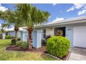 Light blue home with two-car garage and landscaped lawn at 801 68Th W St, Bradenton, FL 34209