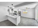Modern kitchen with white cabinets, quartz countertops, and island at 430 Tanager Rd, Venice, FL 34293