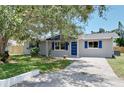 Newly renovated home with gray exterior, blue accents and landscaping at 430 Tanager Rd, Venice, FL 34293