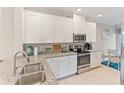 Modern kitchen with stainless steel appliances and granite countertops at 12710 Sorrento Way # 101, Bradenton, FL 34211