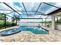 Enclosed pool and spa area with lake view at 405 Maraviya Blvd, Nokomis, FL 34275