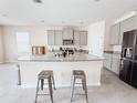 Beautiful kitchen with a large island, granite countertops and stainless steel appliances at 10827 Charlotte Dr, Parrish, FL 34219
