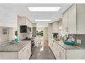 Updated kitchen featuring granite countertops and white cabinets at 846 Jolanda Cir, Venice, FL 34285