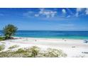 Aerial view of beach showing white sand, ocean, and people enjoying the day at 19 Whispering Sands Dr # 204, Sarasota, FL 34242