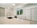 Modern kitchen with white cabinets and high-end appliances at 2231 Wood St, Sarasota, FL 34237