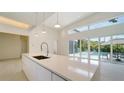 Modern kitchen with white cabinetry and expansive windows at 2231 Wood St, Sarasota, FL 34237