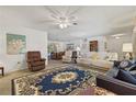 Bright living room featuring comfortable seating and decorative rug at 780 Tarawitt Dr, Longboat Key, FL 34228