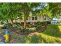 Single story home with mature trees and well maintained landscaping at 780 Tarawitt Dr, Longboat Key, FL 34228