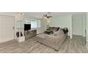 Bright living room with gray sectional sofa and wood-look floors at 2900 Siesta Dr, Venice, FL 34293