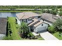 Two-story house with light gray siding, brown tile roof, and landscaping at 17006 Blue Ridge Pl, Lakewood Ranch, FL 34211