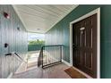 Interior condo hallway with dark brown door and carpeted stairs at 4802 51St W St # 2021, Bradenton, FL 34210