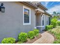 Sidewalk leading to front door with neatly trimmed landscaping at 5732 Puccini St, Nokomis, FL 34275