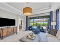 Spacious living area with access to the pool and lanai at 5732 Puccini St, Nokomis, FL 34275