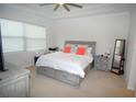 Spacious bedroom with large bed, dresser, and window coverings at 118 Veraza Ct, Nokomis, FL 34275