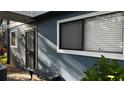 Exterior view of condo building with gray siding and landscaping at 6033 34Th W St # 1, Bradenton, FL 34210