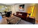 Living room with leather sofa, zebra print ottoman, and dining table at 6033 34Th W St # 1, Bradenton, FL 34210