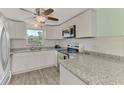 Updated kitchen with granite countertops and stainless steel appliances at 2900 Siesta Dr, Venice, FL 34293