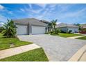 Two story house with three car garage and paver driveway at 12444 Destin Loop, Venice, FL 34293