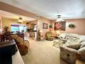 Bright living room featuring comfortable seating and a view into the kitchen at 461 Clover Rd, Venice, FL 34293