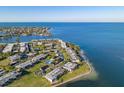 Aerial view of waterfront community with tennis courts and pools at 6300 Flotilla Dr # 71, Holmes Beach, FL 34217