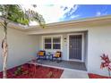 Front porch with two chairs and red mulch landscaping at 3800 Davis Blvd, Sarasota, FL 34232