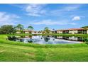 Community features lakefront views and lush landscaping at 3124 Windrush Bourne # 10, Sarasota, FL 34235
