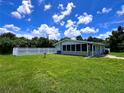 Light teal house with white fence and yard at 3600 Wisteria Pl, Punta Gorda, FL 33950