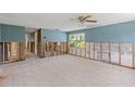 Living room undergoing renovation with tile flooring and a bright window offering natural light at 105 2Nd Se Ave, Ruskin, FL 33570