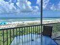 Relax on this balcony overlooking the beach with seating and a table for enjoying the ocean view at 1900 Gulf N Dr # 4, Bradenton Beach, FL 34217