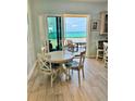 Cozy dining area features a white table with seating for four and beautiful ocean views at 1900 Gulf N Dr # 4, Bradenton Beach, FL 34217