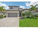 Two-story home showcases a beautiful facade with gray tile roof and landscaping at 5713 Cheech Gln, Lakewood Ranch, FL 34211