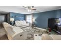 Comfortable living room with white reclining sofas and large TV at 105 2Nd Se Ave, Ruskin, FL 33570