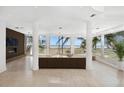 Bright, open living space with floor-to-ceiling windows offering stunning ocean views at 648 Beach Rd, Sarasota, FL 34242