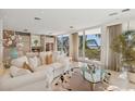 Bright living room with plush seating and sliding doors opening to beach view at 648 Beach Rd, Sarasota, FL 34242