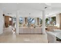 Expansive living room featuring modern decor, tile floors and panoramic ocean views at 648 Beach Rd, Sarasota, FL 34242